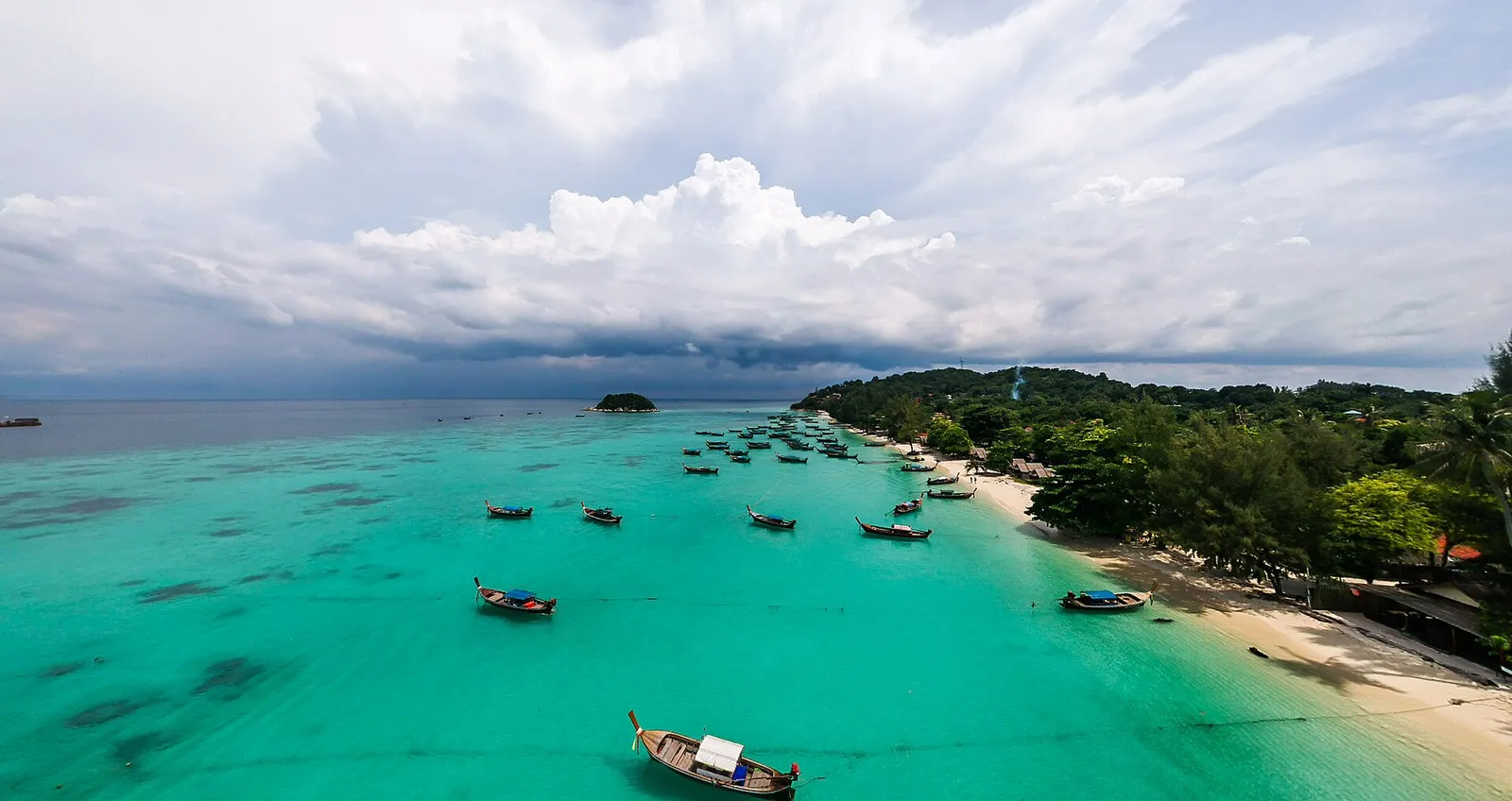 Aerial view of a Koh Lipe beach with longtail boats in turquoise water