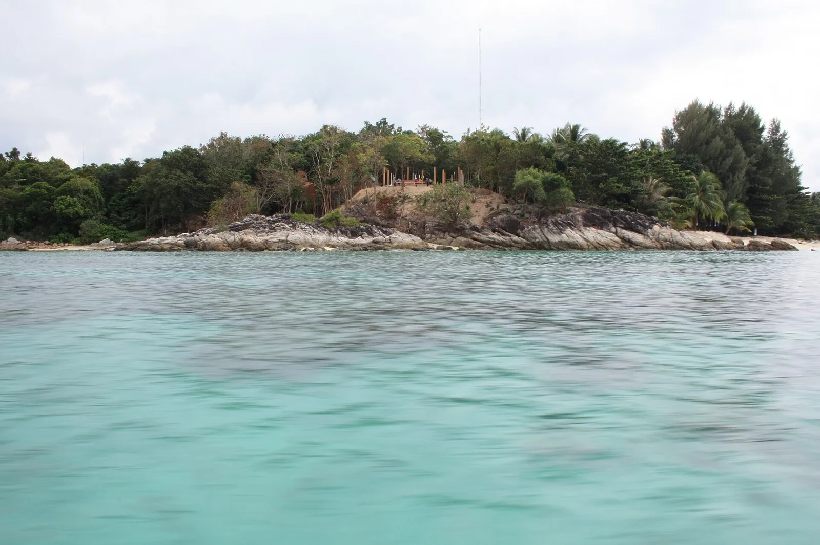 Small rocky islet and clear turquoise water near Koh Lipe
